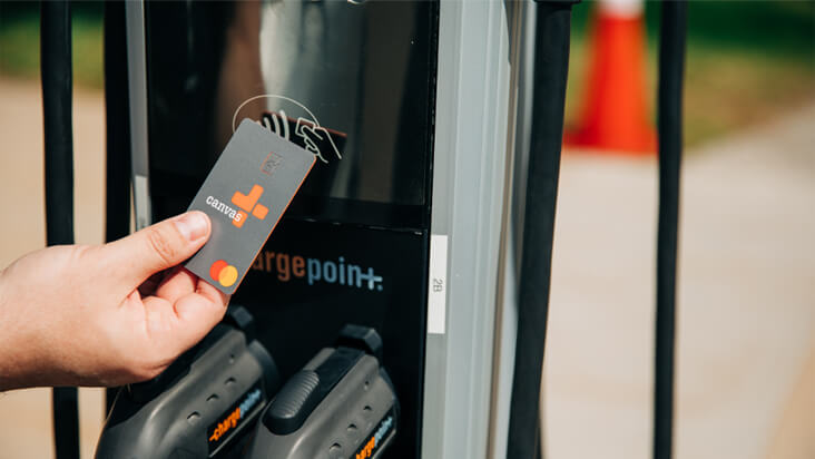 a person using the tap to pay feature on his card at the pump
